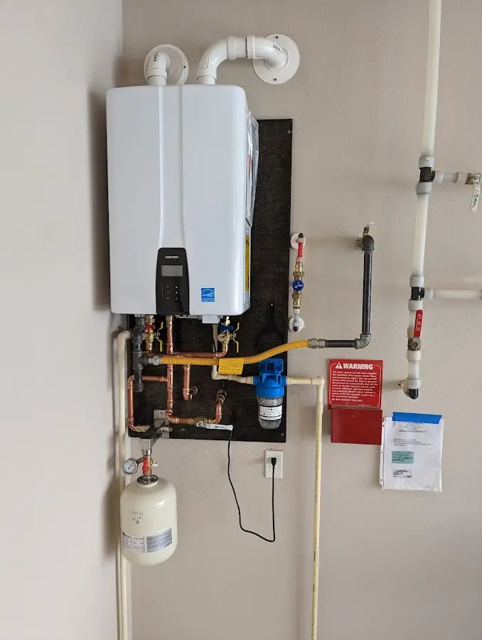 Professional plumber installing copper piping in a Colville home